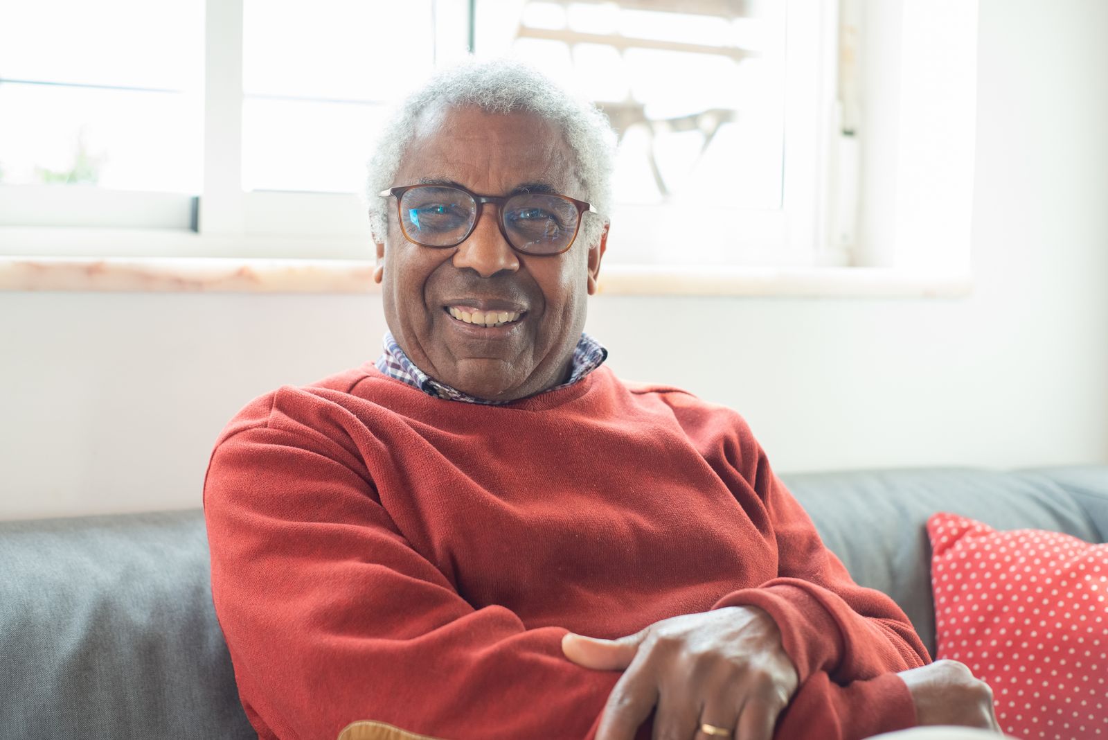 Senior man relaxing at home on his living-room sofa