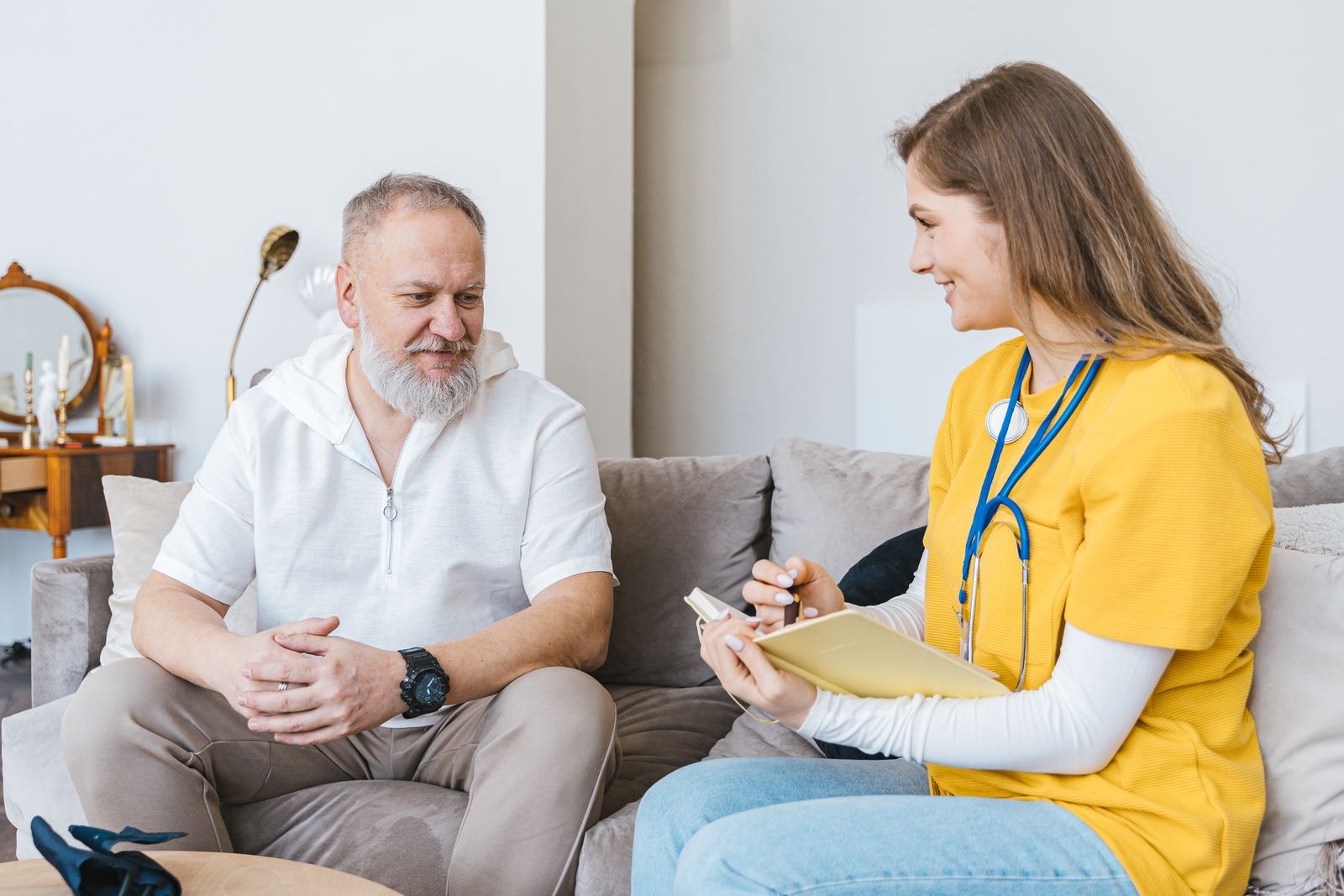 Care guide visiting an older member at home