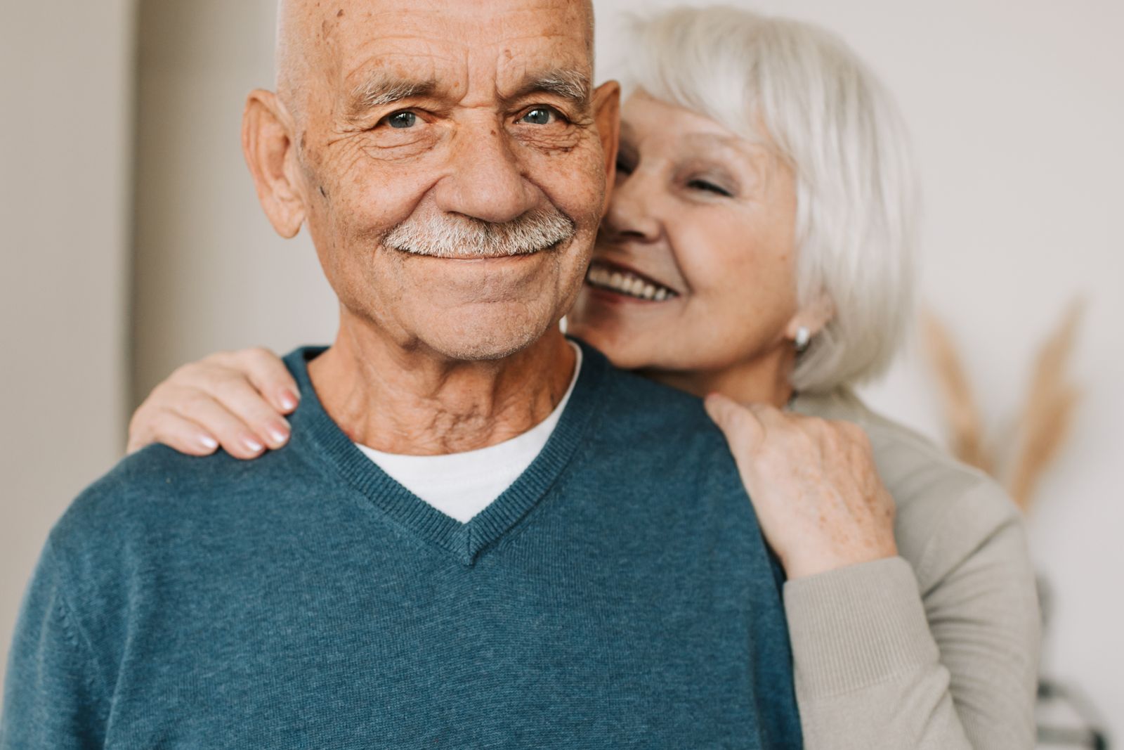 Senior couple embracing at home